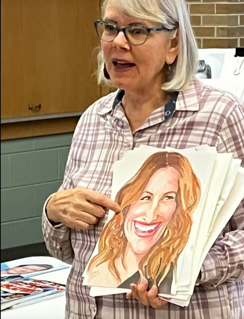 Patty Schmid with a caricature painting